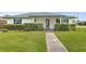 Charming single story home with a neatly maintained lawn and mature hedges at 445 Virginia Ave, St Cloud, FL 34769