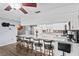 Bright kitchen features a long breakfast bar with seating, white cabinets and modern appliances at 445 Virginia Ave, St Cloud, FL 34769