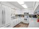 Bright kitchen with white cabinets, modern appliances, and complementary backsplash at 445 Virginia Ave, St Cloud, FL 34769