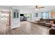 Open-concept living room with hardwood floors connecting to the kitchen at 445 Virginia Ave, St Cloud, FL 34769