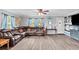 Inviting living room featuring a comfortable leather sectional sofa and updated flooring at 445 Virginia Ave, St Cloud, FL 34769