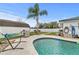Sparkling in-ground swimming pool surrounded by concrete decking and lush tropical landscaping at 445 Virginia Ave, St Cloud, FL 34769