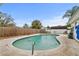 Backyard pool and patio surrounded by a wooden fence offering space for relaxation and outdoor entertaining at 445 Virginia Ave, St Cloud, FL 34769