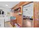 Multi-purpose room with washer, dryer, shelving and view into another room with sofa at 445 Virginia Ave, St Cloud, FL 34769