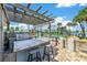 Outdoor kitchen and bar area near the tennis courts and waterfront at 503 N Causeway # 7020, New Smyrna Beach, FL 32169