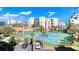 Aerial view showcasing tennis courts, parking, a pool, and surrounding condo buildings at 5300 S Atlantic Ave # 8-404, New Smyrna Beach, FL 32169