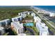 Aerial view showcasing the proximity to the beach and intercoastal waterway and lush setting at 5300 S Atlantic Ave # 8-404, New Smyrna Beach, FL 32169