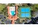 Aerial view highlighting the pool, tennis courts, shuffle board and well-maintained landscaping at 5300 S Atlantic Ave # 8-404, New Smyrna Beach, FL 32169