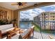 Balcony featuring a fan, patio furniture and a scenic view of the lake and nearby buildings at 5300 S Atlantic Ave # 8-404, New Smyrna Beach, FL 32169