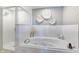Bathroom with a soaking tub, glass-enclosed shower, and decorative wall art for a spa-like feel at 5300 S Atlantic Ave # 8-404, New Smyrna Beach, FL 32169
