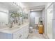 Well-lit bathroom with double sinks, a large mirror, and a glass-enclosed shower at 5300 S Atlantic Ave # 8-404, New Smyrna Beach, FL 32169