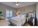 Comfortable bedroom with white linens, ceiling fan, and decorative mirror creating a calming, inviting space at 5300 S Atlantic Ave # 8-404, New Smyrna Beach, FL 32169