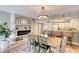 Dining area view with modern light fixture, fireplace, and bar seating at the kitchen counter at 5300 S Atlantic Ave # 8-404, New Smyrna Beach, FL 32169