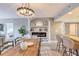 Open-concept dining area featuring modern lighting, fireplace, and a view of the living room and kitchen at 5300 S Atlantic Ave # 8-404, New Smyrna Beach, FL 32169