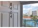 Condo entrance with door displaying the unit number and a peek at the tennis court through the sidelight at 5300 S Atlantic Ave # 8-404, New Smyrna Beach, FL 32169
