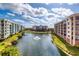 Scenic view overlooking a tranquil pond between the buildings, showcasing a serene community setting at 5300 S Atlantic Ave # 8-404, New Smyrna Beach, FL 32169