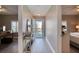 Bright hallway leading to living spaces, featuring console table, and outdoor views at 5300 S Atlantic Ave # 8-404, New Smyrna Beach, FL 32169