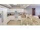 Bright kitchen features white cabinets, granite counters, stainless appliances, and bar seating at 5300 S Atlantic Ave # 8-404, New Smyrna Beach, FL 32169
