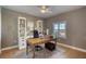 Home office with built-in shelves, a large desk, a ceiling fan, and natural light at 5300 S Atlantic Ave # 8-404, New Smyrna Beach, FL 32169