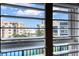 Window view of nearby building, and tennis court at 5300 S Atlantic Ave # 8-404, New Smyrna Beach, FL 32169