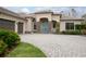 Stately home featuring a beautiful stone facade, arched entry, and manicured landscaping at 564 Bent Pine Ct, Sanford, FL 32771