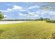 Expansive backyard with lush green lawn and serene lake view, perfect for outdoor activities at 583 Lost Shaker Way, Daytona Beach, FL 32124