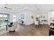 Open living space with tile flooring, white trim, and a view of the lanai and pond at 583 Lost Shaker Way, Daytona Beach, FL 32124