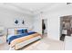 A bright main bedroom features a tray ceiling, carpeted floor, and ensuite bathroom at 583 Lost Shaker Way, Daytona Beach, FL 32124