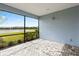 A screened patio features brick flooring and a scenic view of the community lake at 583 Lost Shaker Way, Daytona Beach, FL 32124