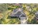 Aerial view of the home showcasing its landscaped yard, roof, and surrounding greenery at 5981 Jandon Ct, Port Orange, FL 32127