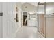 Ensuite bathroom featuring tiled flooring, walk-in shower, and double doors to bedroom at 5981 Jandon Ct, Port Orange, FL 32127