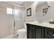 Bathroom featuring a glass shower, a dark vanity, and a round mirror at 5981 Jandon Ct, Port Orange, FL 32127