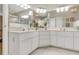 Large bathroom vanity features double sinks and framed mirrors with bright overhead lighting at 5981 Jandon Ct, Port Orange, FL 32127