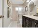 Bathroom features a tiled walk-in shower, and a dark wood vanity at 5981 Jandon Ct, Port Orange, FL 32127