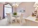 Elegant dining room featuring a glass-top table, seating for six, and decorative chandelier at 5981 Jandon Ct, Port Orange, FL 32127