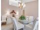 Dining room boasts a glass table, chandelier, and decor accents at 5981 Jandon Ct, Port Orange, FL 32127