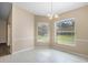 Bright dining room with large windows providing a view of the landscaped yard at 6058 Central Park Blvd, Port Orange, FL 32127