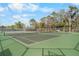 Ground-level view of public tennis courts ready for play under a partly cloudy sky at 6058 Central Park Blvd, Port Orange, FL 32127