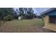 This expansive backyard features mature trees, lush grass, and a storage shed to the rear of the property at 685 E French Ave, Orange City, FL 32763