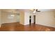 Spacious living room featuring hardwood floors, a ceiling fan, and a light fixture in a neutral color scheme at 685 E French Ave, Orange City, FL 32763
