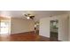 Cozy living room with hardwood floors, ceiling fan, and an open layout leading to the kitchen at 685 E French Ave, Orange City, FL 32763