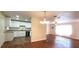 Charming living room and modern kitchen with stainless steel appliances and granite countertops at 685 E French Ave, Orange City, FL 32763