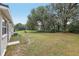This expansive backyard offers plenty of space for recreation and relaxation, surrounded by mature trees and lush greenery at 722 Valencia Ave, Orange City, FL 32763