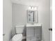 This bathroom features a modern vanity, mirror, and a toilet, all in a well-lit space with a neutral color scheme at 722 Valencia Ave, Orange City, FL 32763