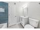 Bathroom with a tiled wall, toilet, vanity, and mirror at 722 Valencia Ave, Orange City, FL 32763
