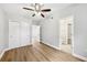 Bedroom featuring wood-look floors, a ceiling fan, and a bathroom at 722 Valencia Ave, Orange City, FL 32763