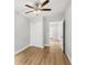 Bedroom featuring wood-look floors, a ceiling fan, closet, and a connecting door at 722 Valencia Ave, Orange City, FL 32763