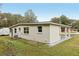 The home's exterior is enhanced by a large, well-kept lawn and a convenient carport, perfect for outdoor enjoyment and parking at 722 Valencia Ave, Orange City, FL 32763