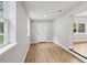 Entryway featuring light gray walls and wood-look floors, offering a bright and welcoming ambiance at 722 Valencia Ave, Orange City, FL 32763