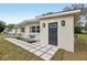 Inviting front entrance with a gray door and well-designed landscaping with stone pavers at 722 Valencia Ave, Orange City, FL 32763